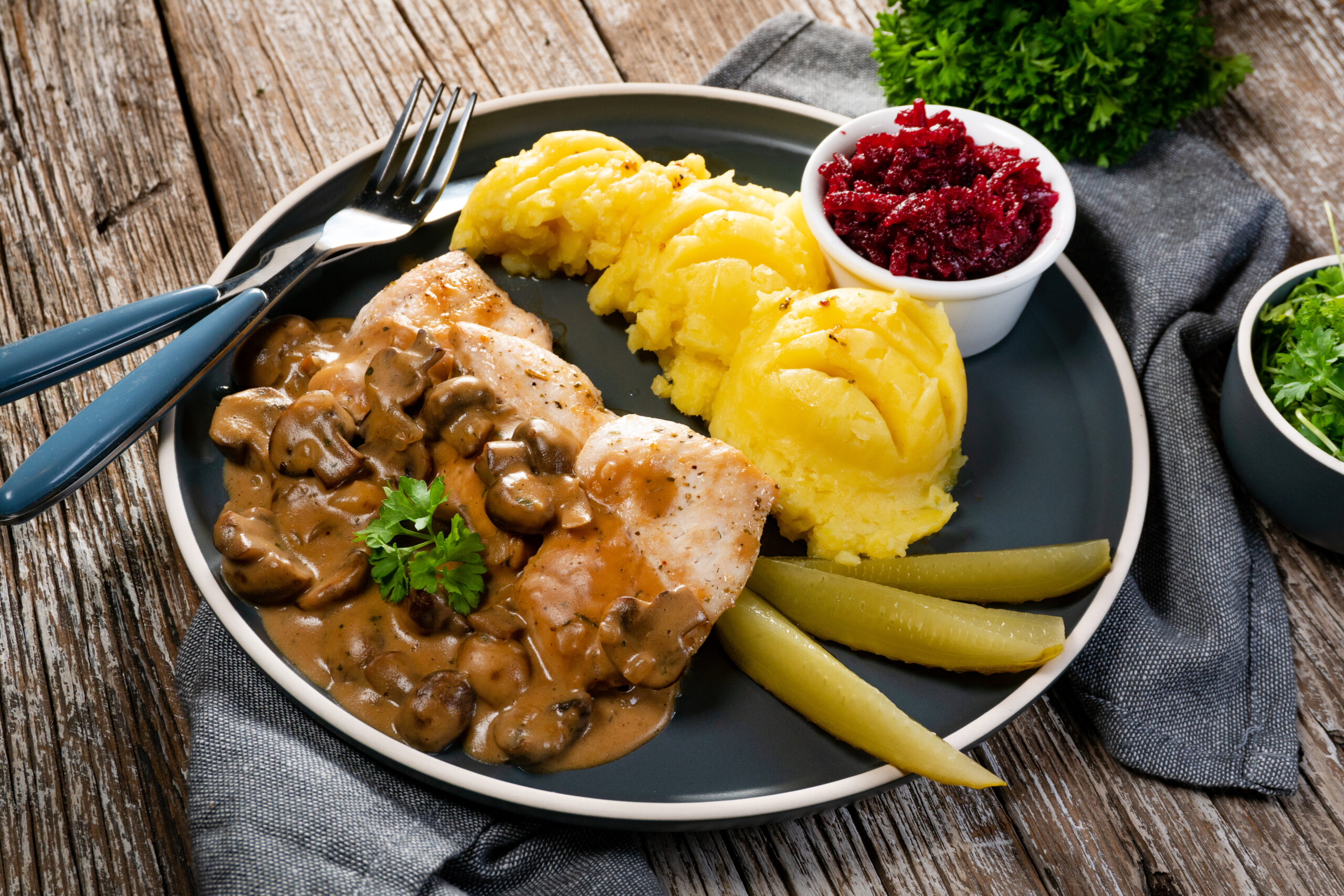 Grilled chicken breast topped with a creamy Chicken of the Woods mushroom sauce, served on a white plate, showcasing a creative use of wild mushrooms in gourmet dishes.