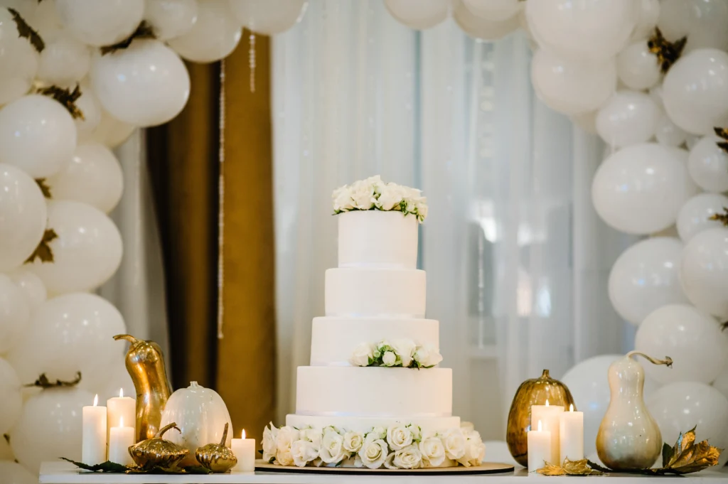 Elegant wedding cake with multiple tiers, adorned with delicate floral decorations and intricate icing details