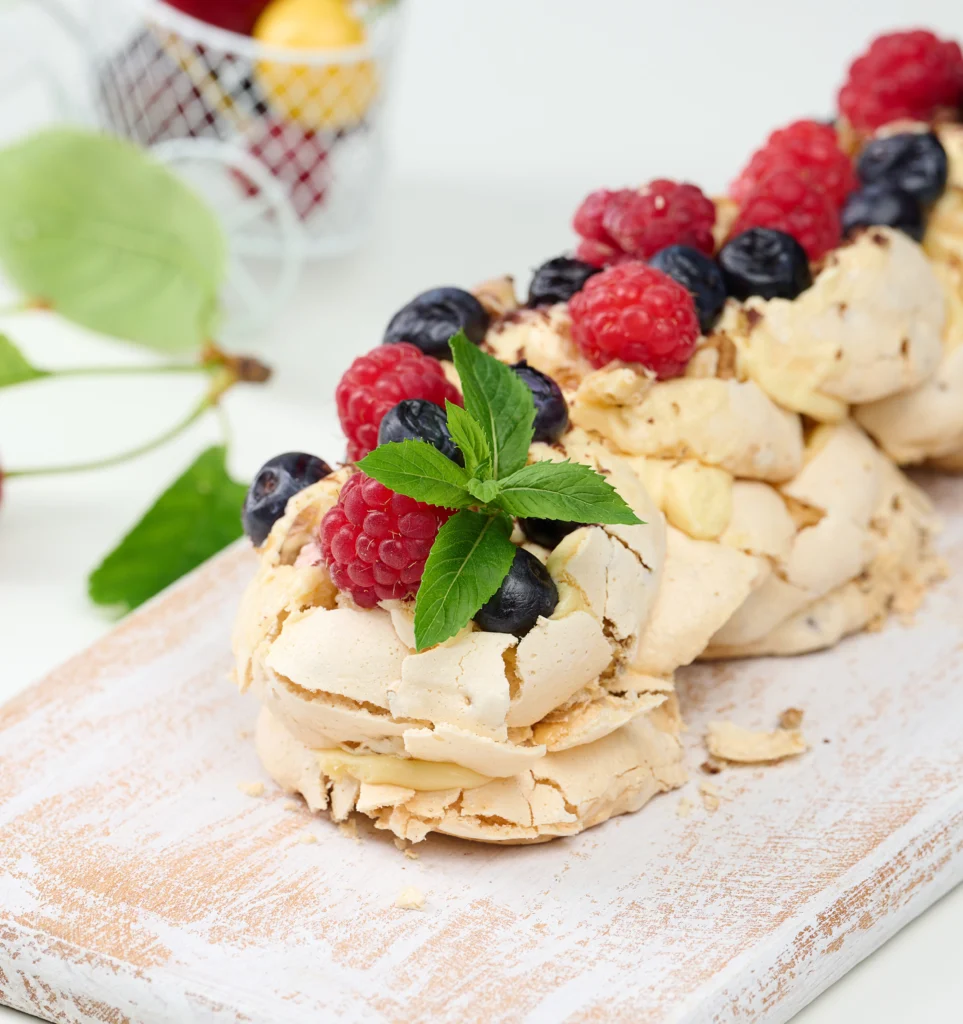 Image of a fricassee cake displayed on a decorative plate, featuring golden-brown crust with visible layers of savory filling, garnished elegantly to enhance its gourmet appeal.