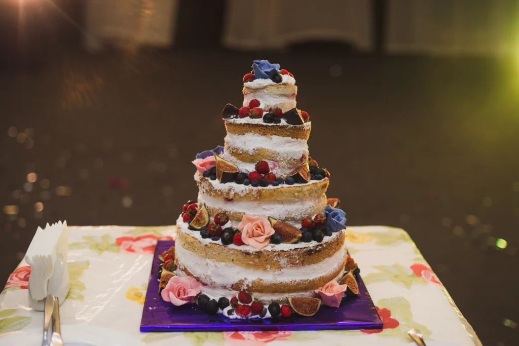 Beautiful wedding cake with cascading flowers and elegant white frosting.