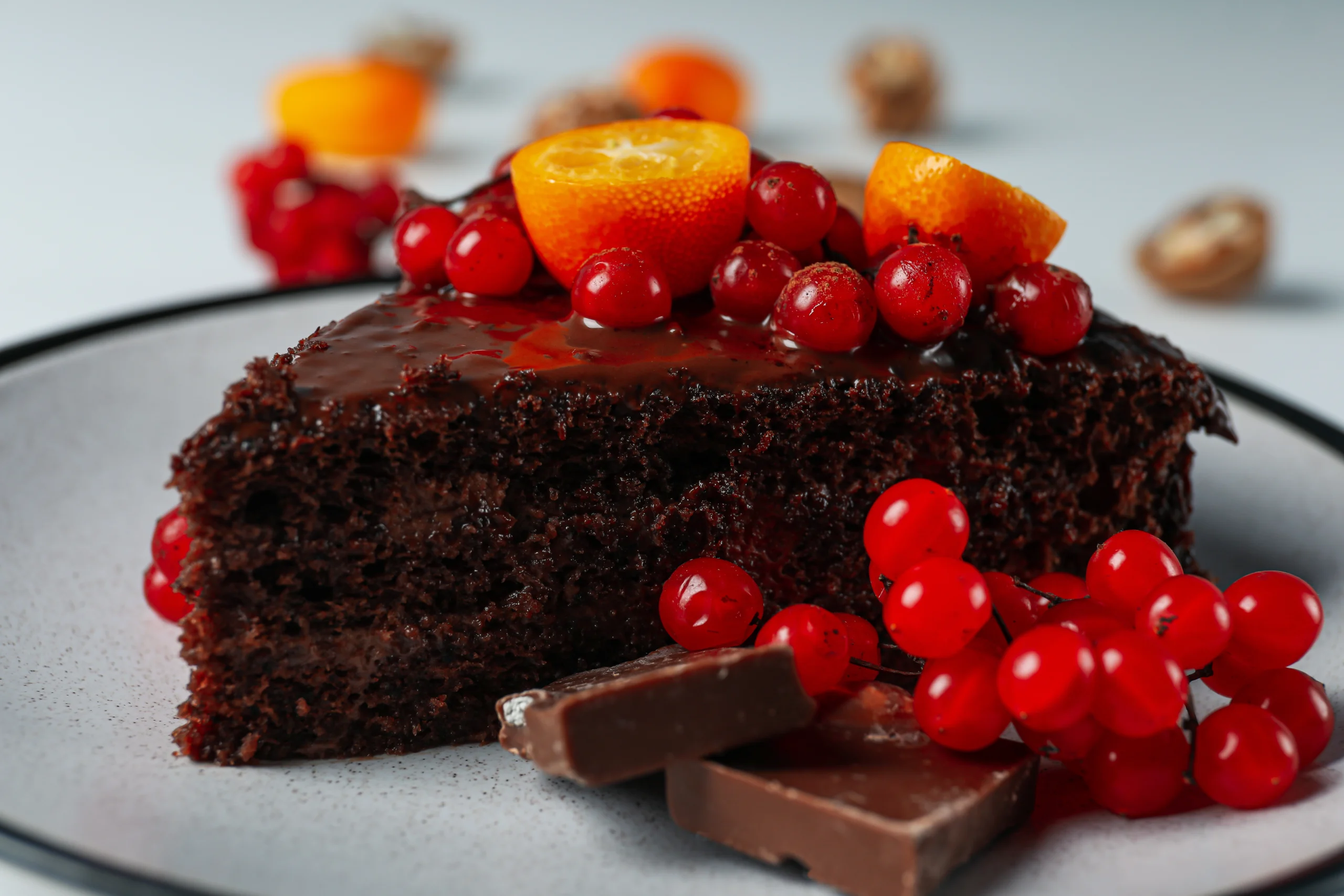 A sumptuous Swiss chocolate cake topped with smooth chocolate ganache and sprinkled with chocolate shavings, showcasing its rich layers and elegant presentation.