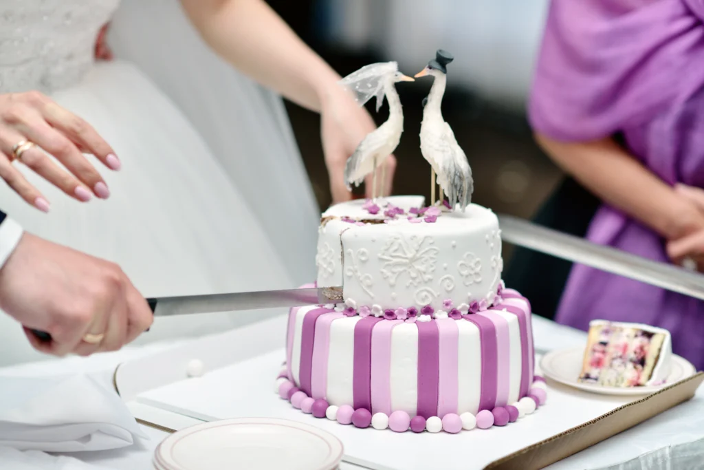 Elegant multi-tiered wedding cake decorated with floral accents and intricate icing designs.