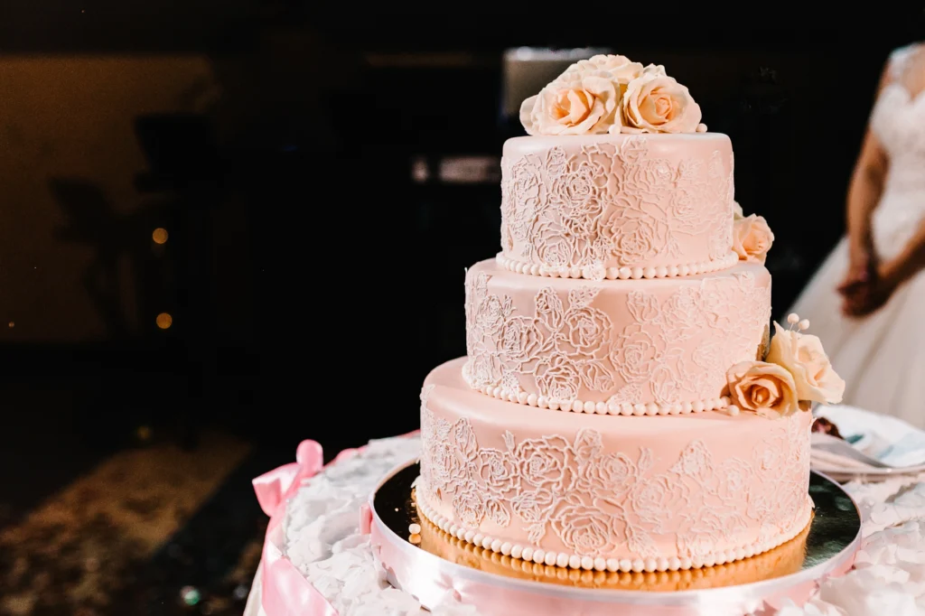 Elegant wedding cake decorated with flowers and intricate icing details