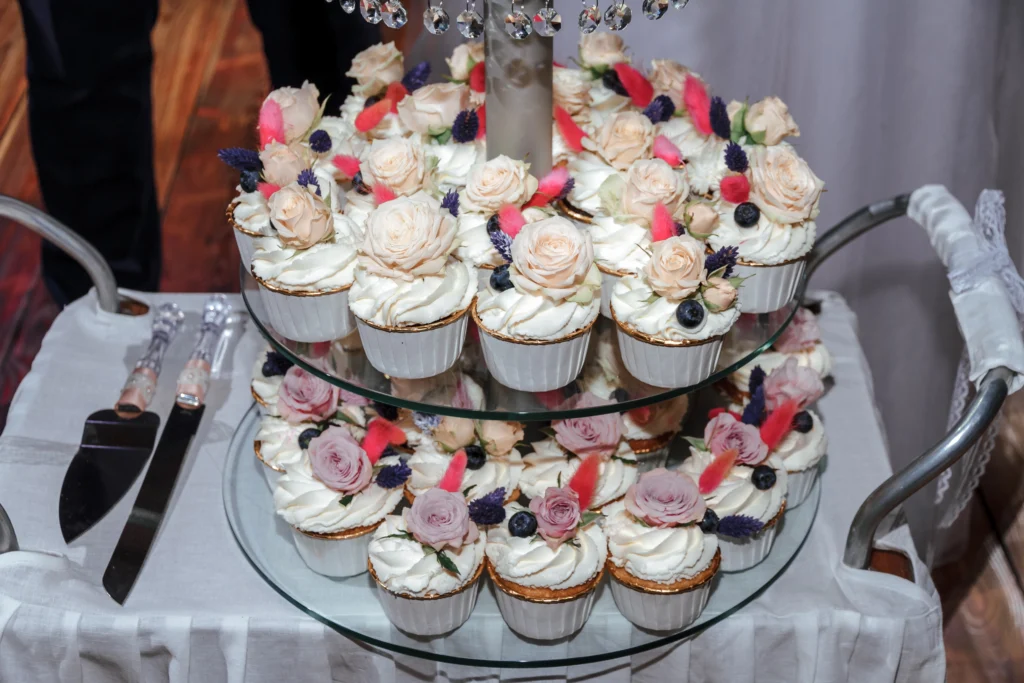 Assorted wedding cupcakes decorated with elegant frosting and flower designs.